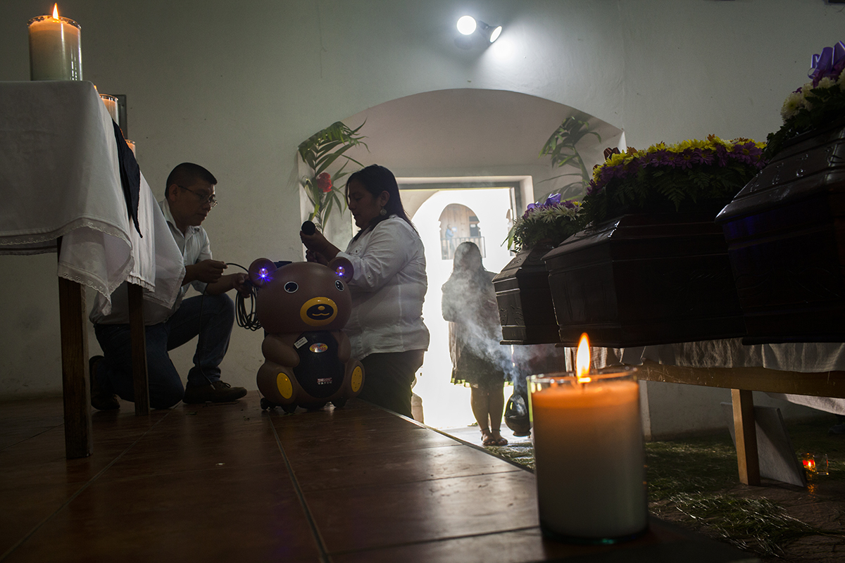 Preparativos para la bendición de los restos de las víctimas en la sala de la pastoral de Cobán